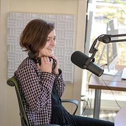 Student sits behind a microphone