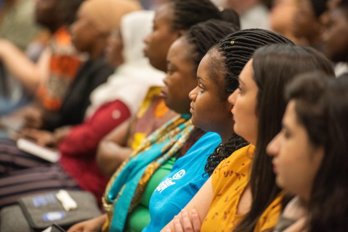 Graduate students listening to a speaker at orientation