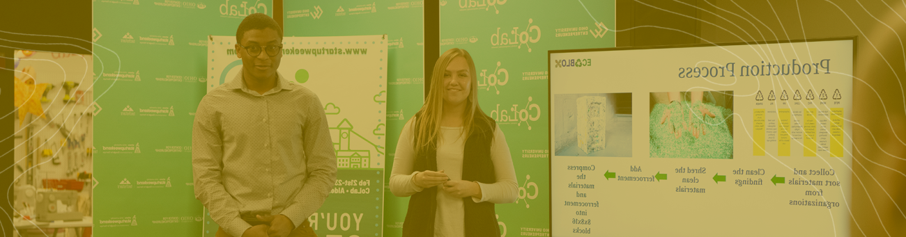 Two students stand at their poster session for entrepreneurship week