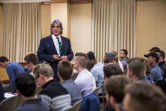 John McNellis speaks to a group of students